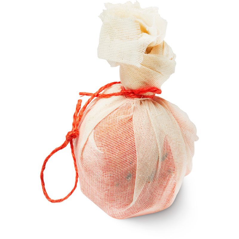 Bonfire bath bomb, an orange bath bomb, wrapped in a muslin cloth, tied up with orange twine.