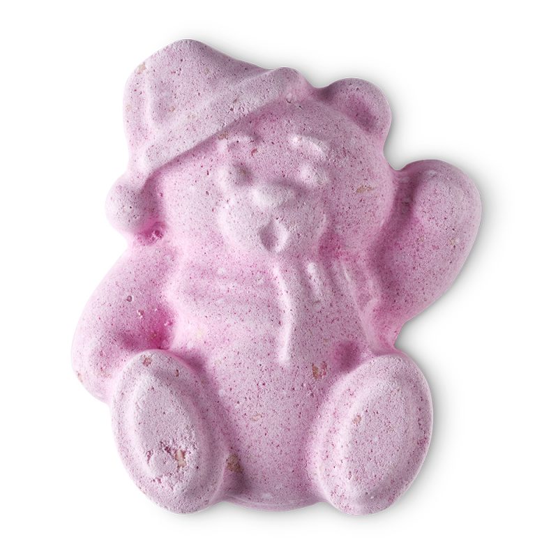 Butterbea, a teddy bear-shaped bath bomb of a pale pink colour. The bear wears a nightcap and raises a paw as if to say hello.