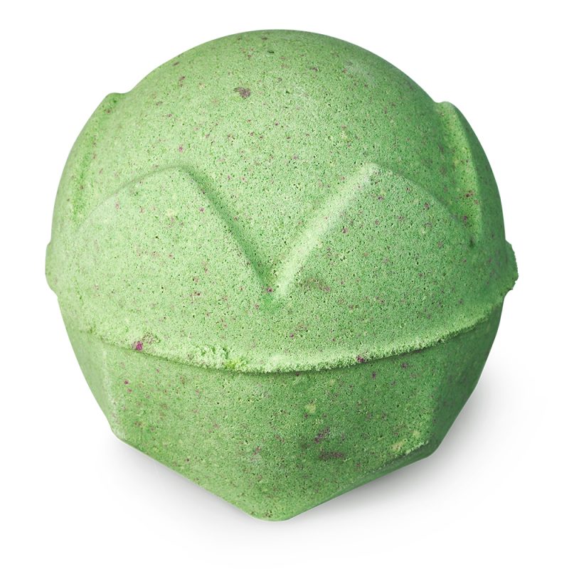 Lord of Misrule bath bomb, a light green sphere with a crown design, with subtle pink blotches all over.