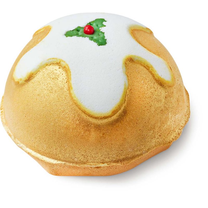 Golden Pudding, a golden bath bomb with a white insert reminiscent of a flowing pudding glaze, topped by holly decorations.